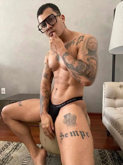 Man wearing glasses wearing Dominic Albano Collection black Tencel thong